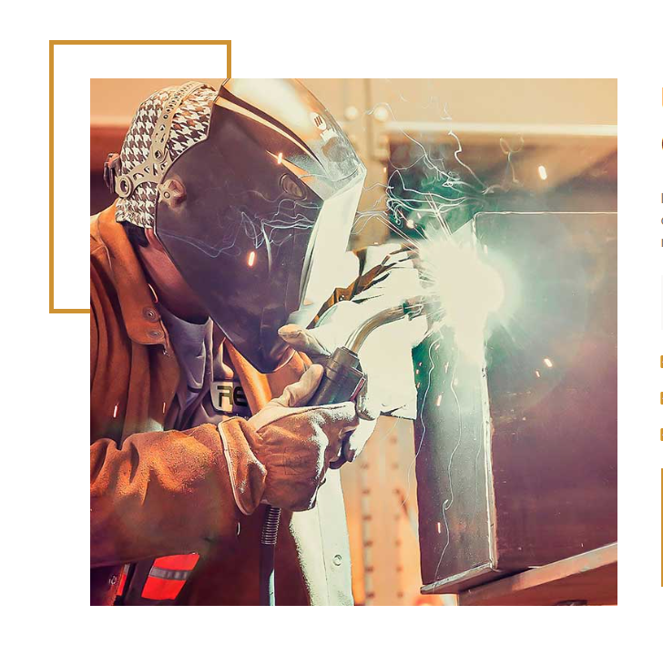 Professional welder striking an arc in protective gear